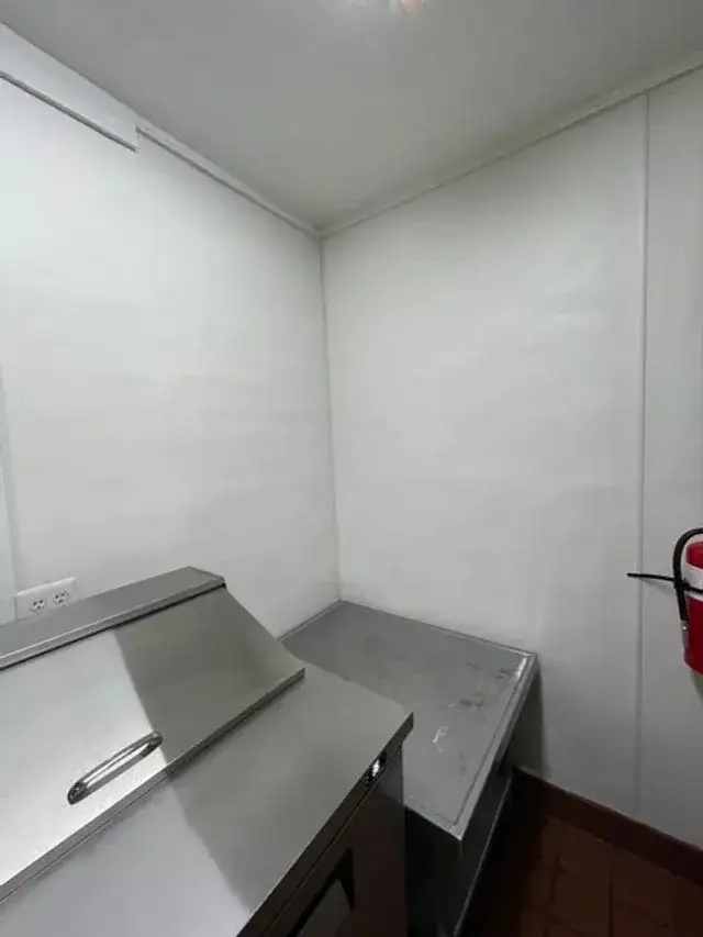 A stainless prep counter in a commercial kitchen after cleaning