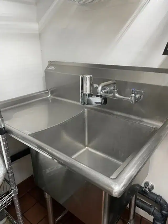 A stainless commercial three-compartment sink cleaned in a Central Oregon business