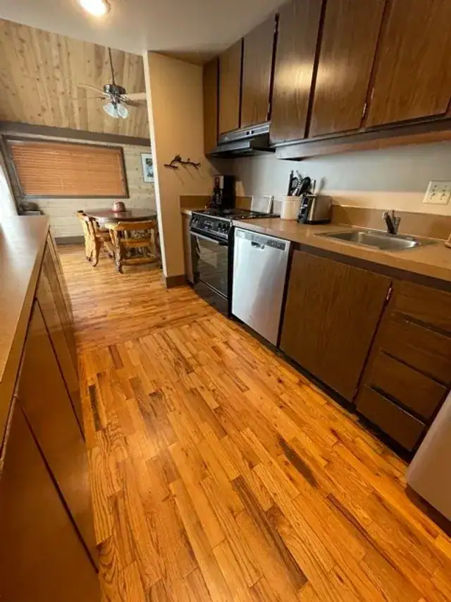 A shining oak floor in a wood-cabinet kitchen