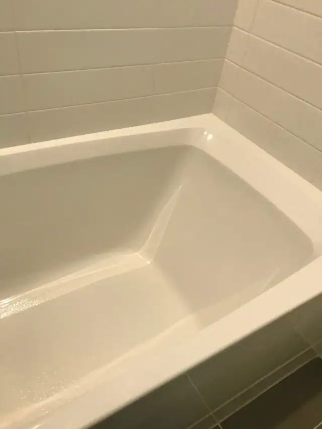 A clean white soaking tub in a vacation rental bathroom